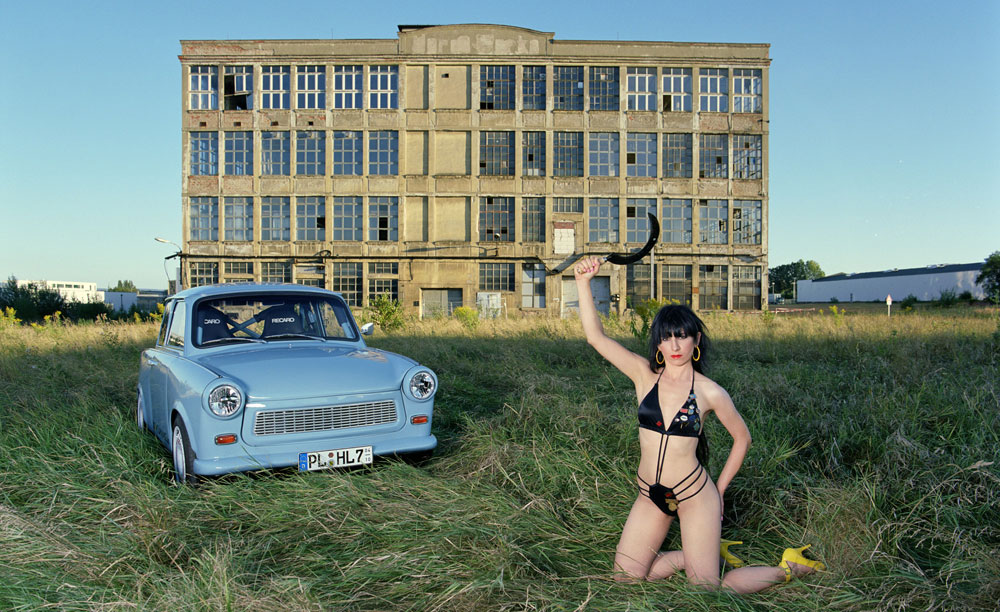 artist Liz Cohenis posing in front of the ancient Horch factory building